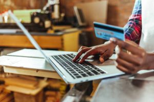 credit repair specialist holding a credit card and looking for way to build business credit
